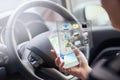 Person, hands and smartphone with hologram in car with digital maps for smart driving and assist with navigation. Woman