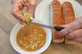 Person hands squeezing a fresh lime into a lentil soup