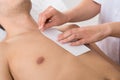 Person Hands Waxing Man's Chest Royalty Free Stock Photo