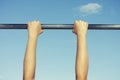 Person hanging on horizontal bar