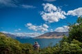 Person with hat takes a picture of lake Wanaka in New Zealand Royalty Free Stock Photo
