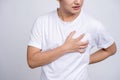 A person having a heart attack. Young asian man had chest pain and held his hand on his chest Royalty Free Stock Photo