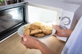 Person Heating Fried Food In Microwave Oven