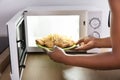 Person Heating Fried Food In Microwave Oven Royalty Free Stock Photo