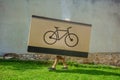 Person hide and carrying an enormous box marked with a bike logo Royalty Free Stock Photo