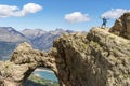 Person hiking, admiring the views of the mountain, in summer.