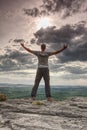 Person in hiking clothing with raised arms Royalty Free Stock Photo