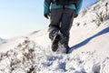 Person hiking on the mountaintop covered with snow low angle view Royalty Free Stock Photo