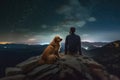 A person with his golden retriever pet looking a starry sky