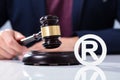 Person Hitting The Gavel Near Trademark Icon