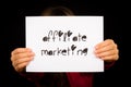 Person holding affiliate marketing sign