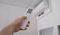 Person is holding air conditioner remote control Royalty Free Stock Photo