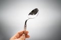 Person Holding Bend Stainless Steel Spoon