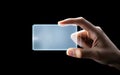 a person holding a blank white rectangular object in their hand