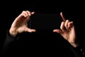 Person holding in both hands mobile phone horizontally