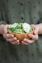 Person holding a bowl of salad made of dehydrated onions