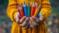 Person Holding a Bunch of Colored Pencils Royalty Free Stock Photo