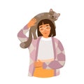 Person holding cat on shoulders, young happy woman playing with furry funny animal