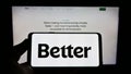 Person holding cellphone with logo of American financial company Better Mortgage (Better.com) on screen with webpage.