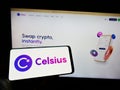 Person holding cellphone with logo of US crypto company Celsius Network LLC on screen in front of business webpage. Royalty Free Stock Photo