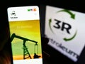 Person holding cellphone with web page of Brazilian oil and gas company 3R Petroleum SA on screen in front of logo.