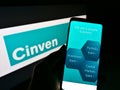Person holding cellphone with web page of British private equity firm Cinven Partners LLP on screen with logo.
