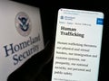 Person holding cellphone with webpage of US Department of Homeland Security (DHS) on screen in front of seal. Royalty Free Stock Photo