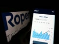 Person holding cellphone with webpage of US engineering company Roper Technologies Inc. on screen with logo. Royalty Free Stock Photo