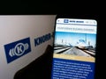 Person holding cellphone with website of German manufacturing company Knorr-Bremse AG on screen in front of logo. Royalty Free Stock Photo