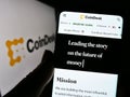 Person holding cellphone with website of US crypto news company CoinDesk Inc. on screen in front of logo. Royalty Free Stock Photo