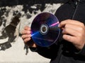 A person holding a compact disc in their hands Royalty Free Stock Photo