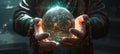 a person holding a crystal ball filled with light on a dark background Royalty Free Stock Photo