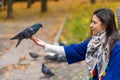 The person is holding a dove on the hand. Feeds pigeons in the park. Tame a pigeon