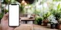 Generative AI Modern smartphone held in hand with blank screen in outdoor garden setting with plants business conc Royalty Free Stock Photo