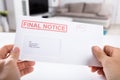 Person Holding Final Notice Envelope Royalty Free Stock Photo