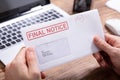 Person Holding Final Notice Envelope Royalty Free Stock Photo