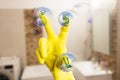 Person holding fingers on cleaning items from screen