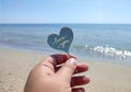 Person holding fingers stick shape heart words Love you background sand beach Royalty Free Stock Photo