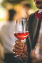 Person holding a glass of red wine in their hand Royalty Free Stock Photo