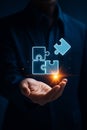 Person holding glowing puzzle pieces in hand symbolizing connection and solution Royalty Free Stock Photo