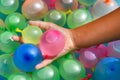 Person holding a handful of colorful water bombs Royalty Free Stock Photo