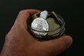 Person holding a jar full of Australian coins