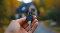 A person holding a key in their hand with the house behind them, AI Royalty Free Stock Photo