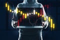 Person holding a laptop with double exposure of stock market graphics on a dark background, concept of business analytics Royalty Free Stock Photo