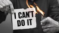 Person Holding Lighter Burning Sign Saying I Cant Do It, Overcoming Self Doubt