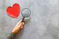 person holding magnifying glass and search love Royalty Free Stock Photo