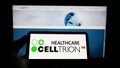 Person holding mobile phone with logo of biopharmaceutical company Celltrion Inc. on screen in front of business web page.