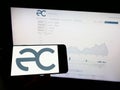 Person holding mobile phone with logo of Chilean company Empresas Copec S.A. on screen in front of business web page. Royalty Free Stock Photo