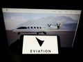 Person holding mobile phone with logo of electric aircraft company Eviation Aircraft Ltd. on screen in front of web page.