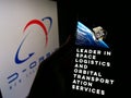 Person holding mobile phone with webpage of aerospace company D-Orbit SpA on screen in front of logo